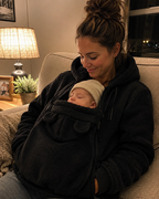 Evening cuddle — baby asleep in black Snoozeroo fleece pouch hoodie